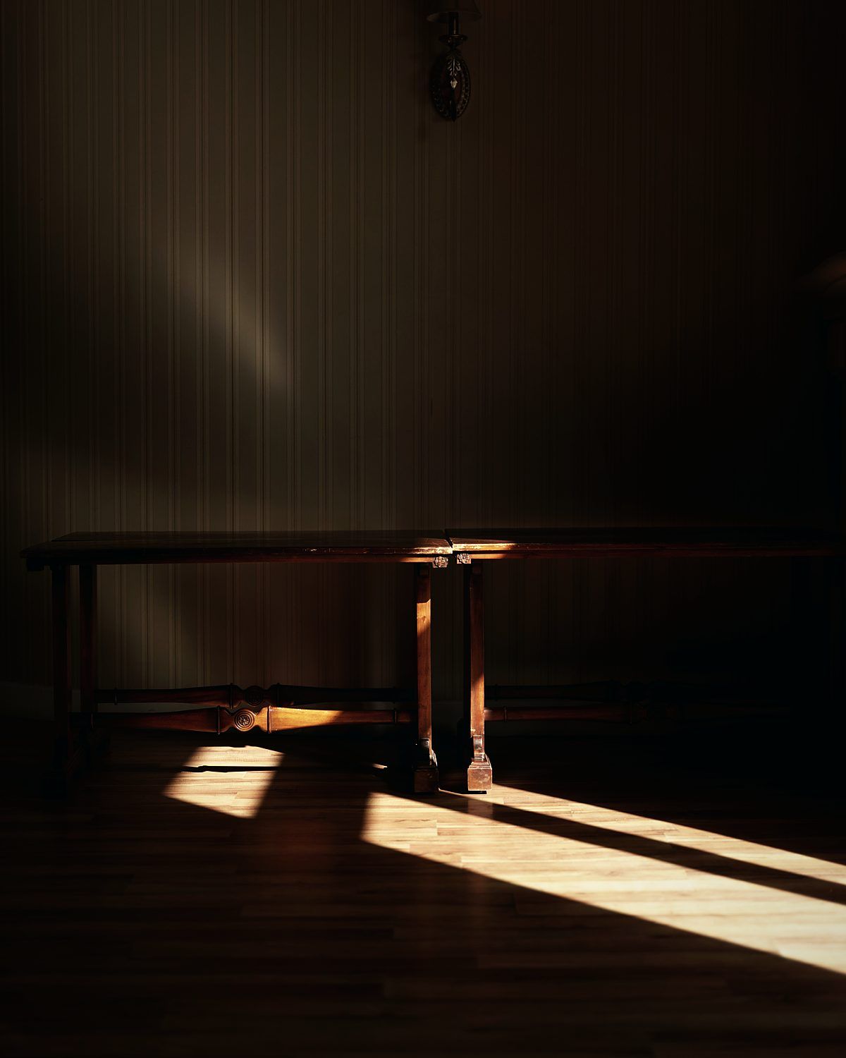 Late afternoon light falling across the floor of an empty room